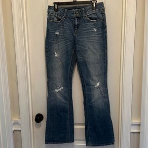 Long length distressed wide legged jeans